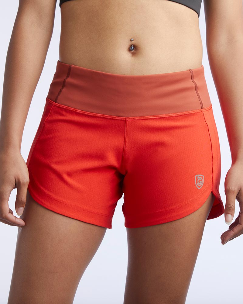 Excel women's training shorts by Goal Five in cinnabar and poppy colors, designed for comfortable workout sessions.
